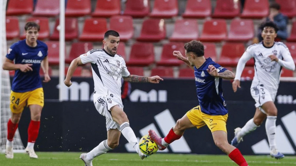 Agus Medina peleando un balón dividido con Carrique